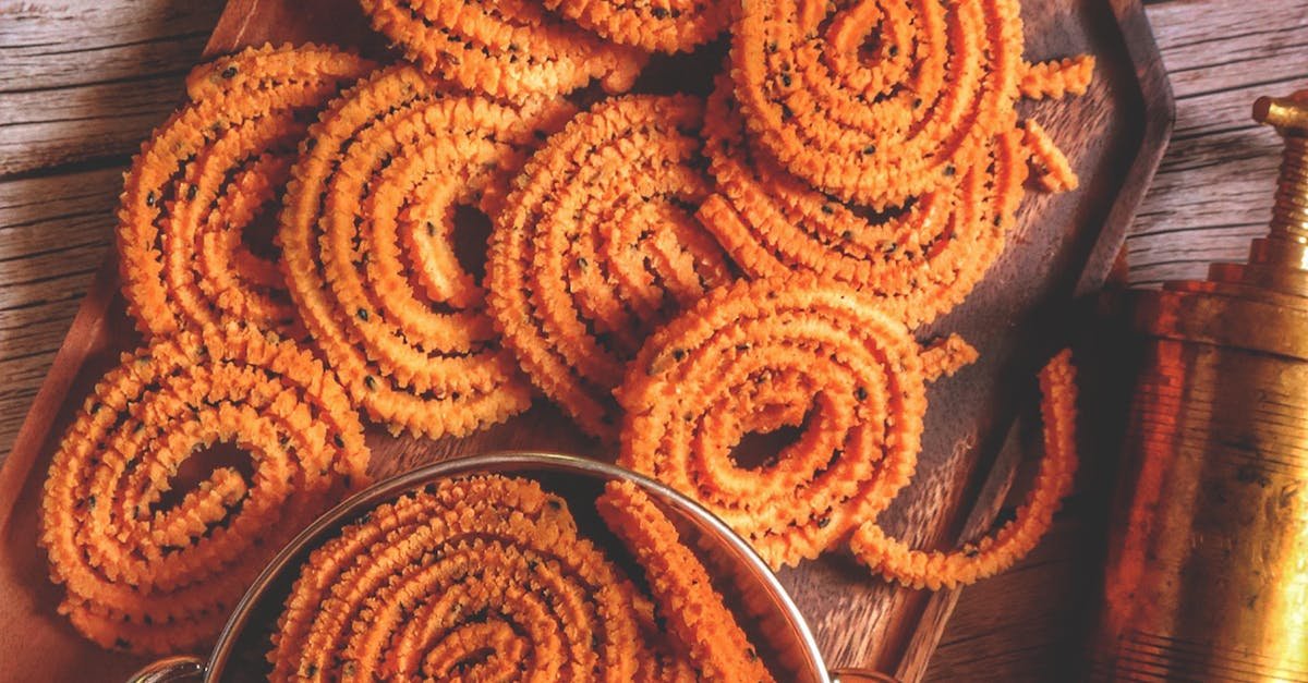 Enjoy traditional Indian chakli snacks served with tea, captured in a warm, rustic setting.